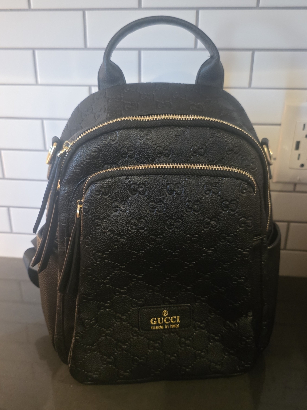 Black Embossed Backpack with Gold Hardware